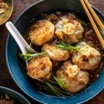 Sesame Chicken Dumplings in Spicy Broth with Garlic Crisps.